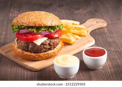 Homemade delicious hamburger with beef, onion, tomato, lettuce and cheese. Fresh burger close up on wooden rustic table with potato fries. Cheeseburger. Burger. - Powered by Shutterstock