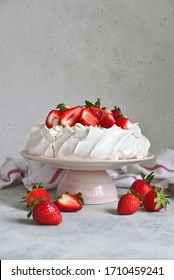 Homemade delicious meringue cake "Pavlova" with fresh straberry and mascarpone on a white background.