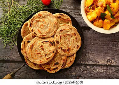 Homemade Delicious Whole Wheat Paratha, Porotta Served With Potato Masala Curry.