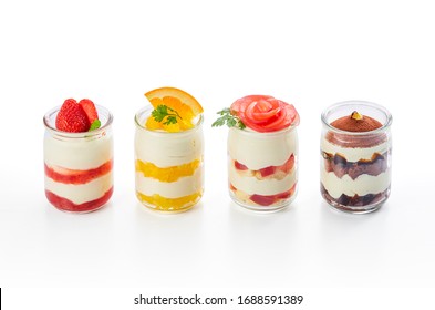 homemade dessert of fruits with  no-bake cheesecake in glass cup on white background