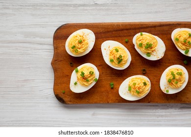 Homemade Deviled Eggs With Chives On A Rustic Wooden Board, View From Above. Flat Lay, Top View, Overhead.