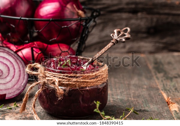Homemade DIY natural healthy red onion marmalade\
jam, confiture, chutney in jar. Vegetable jam on wooden background.\
French cuisine, banner\
format.