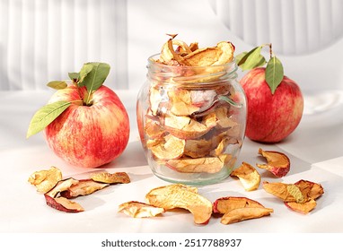 Homemade dried apple slices on kitchen table,Apple chips in glass jars on sunny background,Detox diet and weight loss concept,Natural food for healthy lifestyle,Advertisement for store, - Powered by Shutterstock