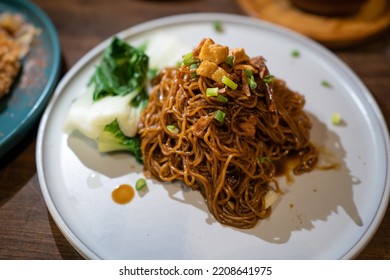Homemade dry Wonton noodle (Wan Tan Mee) with isolated brown background.  - Shutterstock ID 2208641975