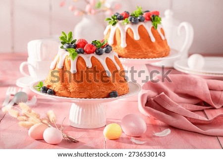 Homemade Easter ring cake known as babovka cake. Easter spring background with flowers and easter eggs.