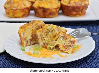 Homemade Egg, Bacon And Cheese Breakfast Muffins.  On Muffin Cut Open On A Plate With A Fork.