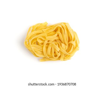 Homemade egg pasta tagliatelle. Raw nest noodles, uncooked ribbon fettuccine, dry long rolled macaroni isolated on white background top view - Powered by Shutterstock