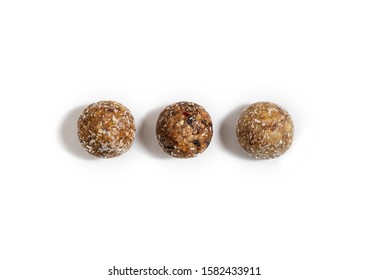 Homemade energy balls with dried apricots, raisins, dates, prunes, walnuts, almonds and coconut. Healthy sweet food. Energy balls on a white background. Flat lay, top view.