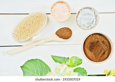 Homemade Exfoliating Scrub Ingredients. Ground Coffee, Himalayan Pink Salt, Clay Powder And Body Brush On Wooden Table. Spring Body Care, Cleansing And Renewal For Skin. Top View