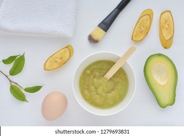 Homemade Face Mask With Avocado, Egg And Banana, Natural Cosmetics, Flat Lay On White Background.