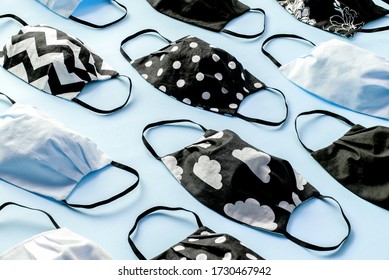 Homemade Face Protective Masks On Blue Flat Lay Background. Reusable Fabric Face Masks Against Coronavirus, Covid-19 Or Flu. Pattern Of Medical Mask