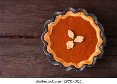 Homemade Fall Pumpkin Pie. Top Down View On A Dark Rustic Wood Background.