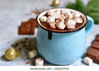 Homemade festive hot chocolate in a blue vintage cup on a light slate, stone or concrete background. - Powered by Shutterstock