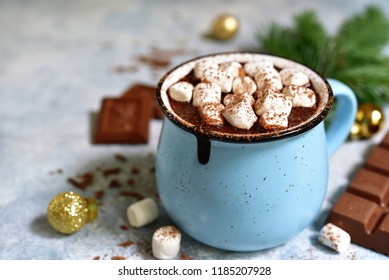 Homemade festive hot chocolate in a blue vintage cup on a light slate, stone or concrete background. - Powered by Shutterstock