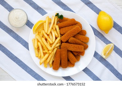 Homemade Fish Sticks And Fries With Tartar Sauce On A White Wooden Table, Top View. Flat Lay, Overhead, From Above. 