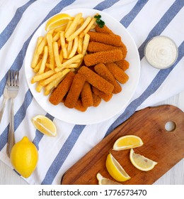 Homemade Fish Sticks And Fries With Tartar Sauce On A White Wooden Table, Top View. Flat Lay, Overhead, From Above. 