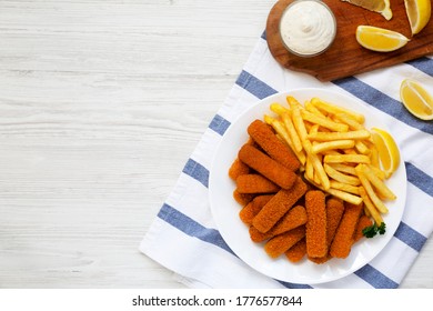 Homemade Fish Sticks And Fries With Tartar Sauce On A White Wooden Background, Top View. Flat Lay, Overhead, From Above. Copy Space.