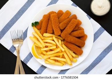 Homemade Fish Sticks And Fries With Tartar Sauce On A Black Background, Top View. Flat Lay, Overhead, From Above.
