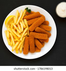 Homemade Fish Sticks And Fries With Tartar Sauce On Black Surface, Top View. Flat Lay, Overhead, From Above.