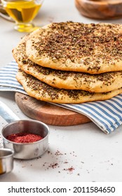 Homemade Flatbread With Herbs And Sumac On A Gray Concrete Background.