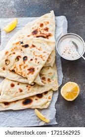 Homemade Flatbread Stuffed With Potato, Herbs And Cheese With Yogurt Sauce And Lemon. Close Up And Overhead View.