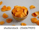 Homemade Flavored Paprika Potato Chips in a Bowl, side view.