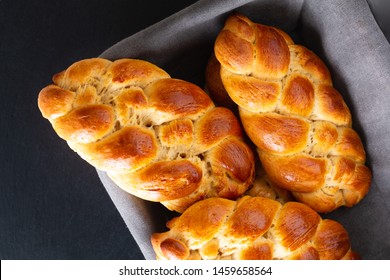 Homemade food concept fresh baked bread braid challah dough in bread basket with copy space