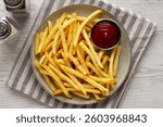 Homemade French Fries and Ketchup on a Plate, top view. Flat lay, overhead, from above.