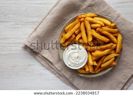 Homemade French Fries with Ranch Dressing on a Plate, top view. Flat lay, overhead, from above. Copy space.