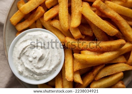 Homemade French Fries with Ranch Dressing on a Plate, top view. Flat lay, overhead, from above. Close-up.