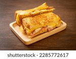 Homemade French toast ham bacon cheese sandwich with egg