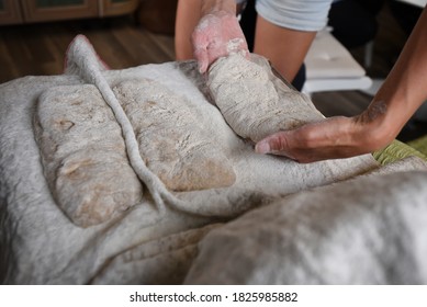 Home-made fresh bread. Woman 
 puts 3 formed white wheat pieces of dough on a table for rise and get ready for baking.  - Shutterstock ID 1825985882