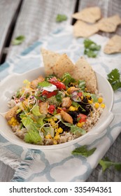 Homemade Fresh Organic Chicken Chipotle Black Bean Salad Bowl On A Blue And White Place Mat On An Old Weathered Barn Wood Table