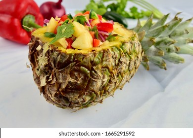 Homemade Fresh Pineapple Salsa in Pineapple Bowl on White Background. Selective Focus
