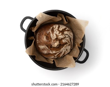 Homemade Freshly Baked Traditional Rye Bread Isolated In Dark Metal Pan With Pergament Paper Isolated On White Background, Top View, Round Whole Loaf Of Rustic Organic Cereal Bread With Crispy Crust