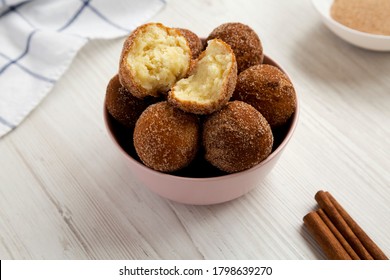 Homemade Fried Donut Holes In A Pink Bowl On A White Wooden Background, Side View. 