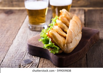 Homemade Fried Fish Sandwich. Fried Catfish Po Boy On Rustic Wooden Table 