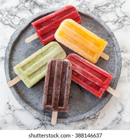 Homemade frozen ice cream popsicles in various flavors