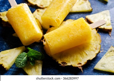Homemade fruit popsicle with pineapple and mint. Selective focus. - Powered by Shutterstock