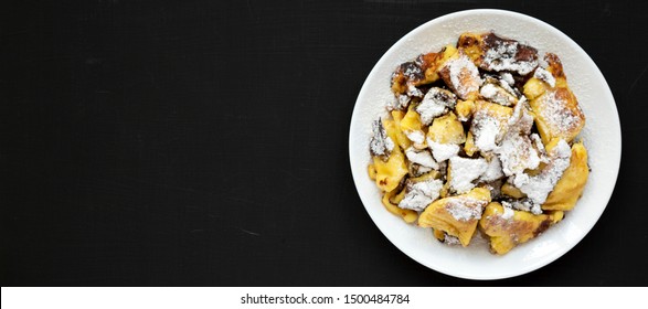 Homemade German Kaiserschmarrn Pancake On A Black Surface, Top View. Flat Lay, Overhead, From Above. Space For Text.