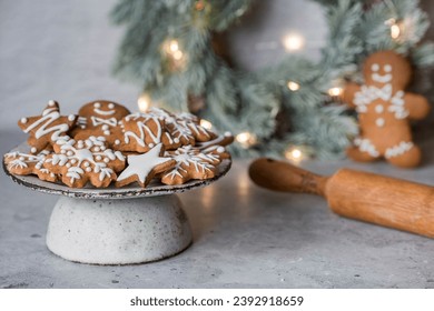 Homemade gingerbread Christmas cookies in icing sugar. Delicious gingerbread cookies on the background of a bokeh of Christmas tree lights. Freshly baked Christmas gingerbread cookies. - Powered by Shutterstock