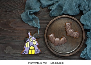 Homemade Gingerbread Cookies In The Form Of Witch House And  Bat On Dark Background. Top View With Copy Space