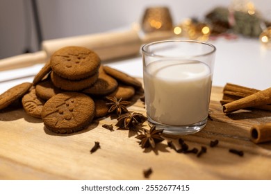 homemade gingerbread cookies with a glass of milk and spices: anise, cloves and cinnamon. traditional Christmas dessert, Christmas and new year celebration - Powered by Shutterstock