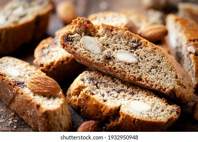 Homemade gluten free biscotti or cantuccini made of buckwheat flour with almonds and chocolate chips on dark rustic wooden background