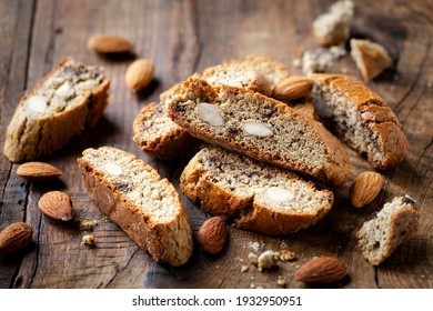 Homemade gluten free biscotti or cantuccini made of buckwheat flour with almonds and chocolate chips on dark rustic wooden background