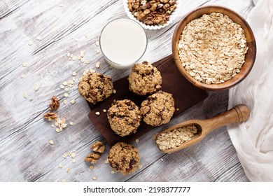 Homemade gluten free oatmeal cookies with dark chocolate and nuts on white wooden background, top view. Healthy eating, ancient grain food concept. - Shutterstock ID 2198377777