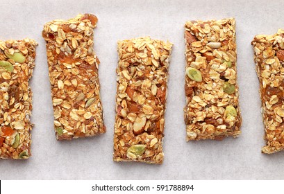 Homemade granola bars on white baking paper. Top view. - Powered by Shutterstock