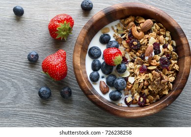 Homemade  granola with  fresh berry in wooden bowl - Powered by Shutterstock