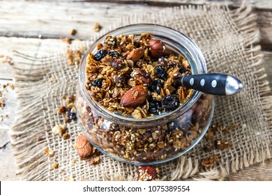 homemade granola in glass jar on rustic wooden table. healthy breakfast - Powered by Shutterstock