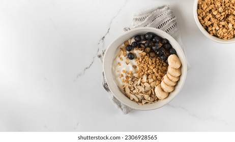 Homemade granola with Greek yogurt, almonds, blueberries and banana in a bowl. Copy space - Powered by Shutterstock